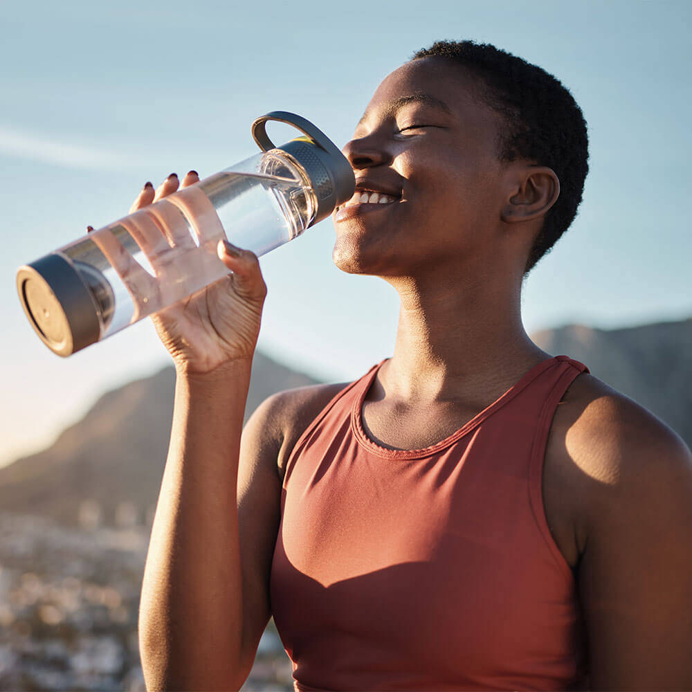 black girl drinking water from bottle